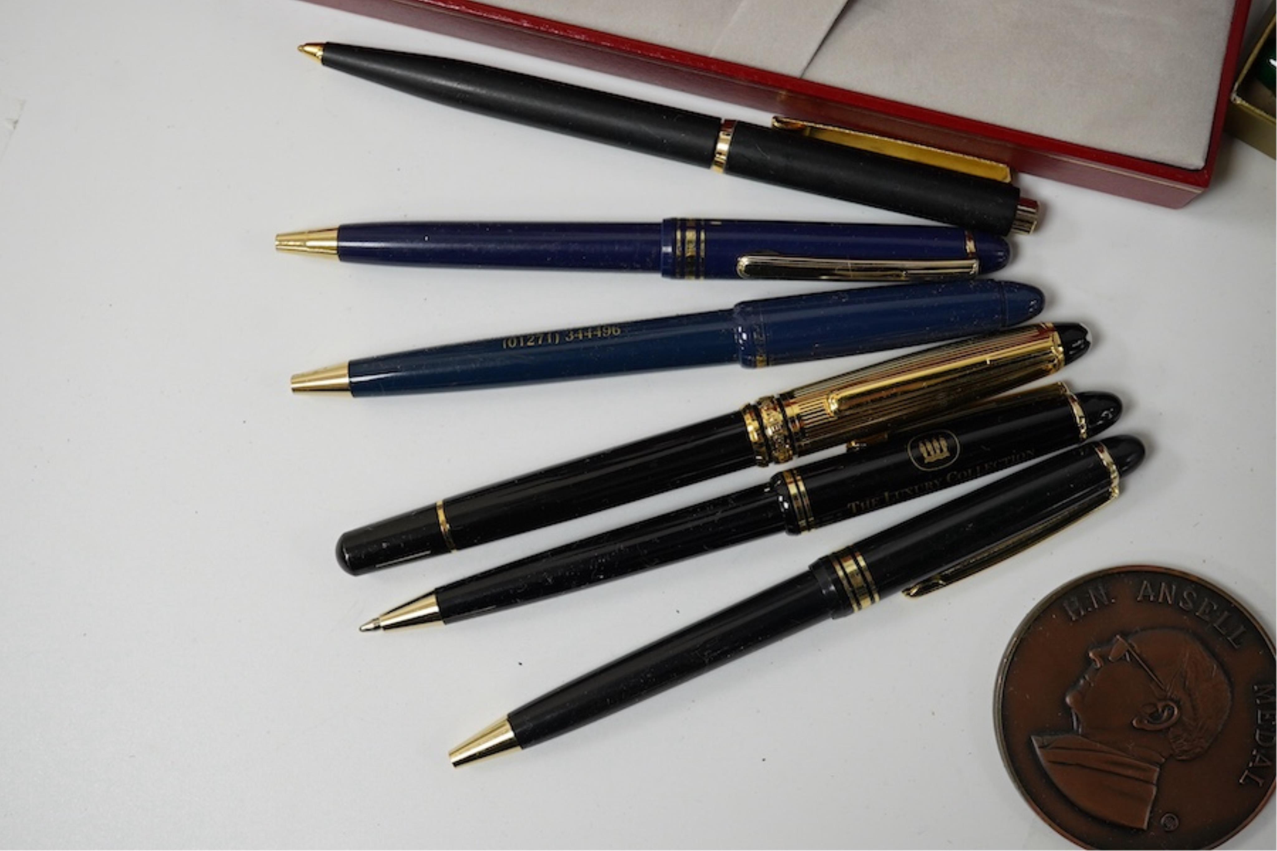 A collection of various pens, a ladies Must de Cartier wrist watch and a H.N. Ansell medal. Condition - varies